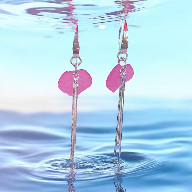 Discover the enchanting allure of these pink sweet pea sterling silver earrings, accented with liquid silver. Their unique design and soft color make them a delightful addition to your jewelry collection, perfect for everyday wear.